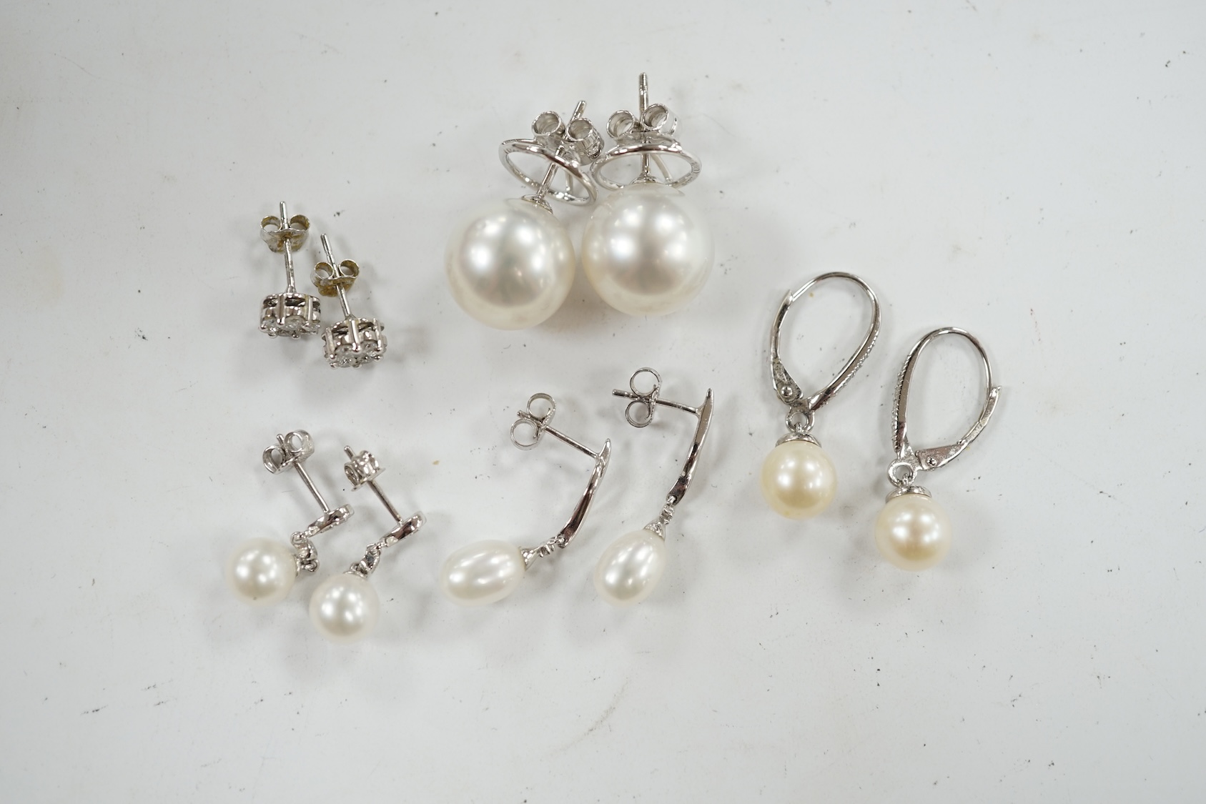 Three assorted modern pairs of 9ct, cultured pearl and diamond chip set earrings, a similar diamond cluster pair and a pair of cultured pearl earrings. Condition - fair to good